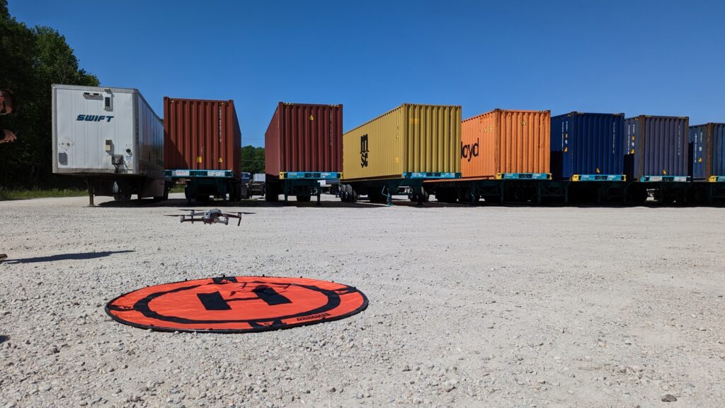 SiteTrax.io Drone taking off from landing location in intermodal container yard.